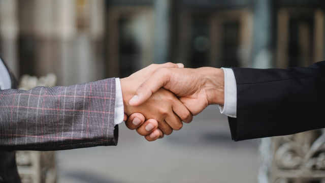 two people are handshaking